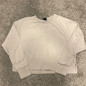 Nike Dri Fit sweater with NIKE on the front and swoosh mark on the sleeve.